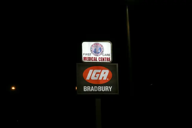 Illuminated IGA sign at night