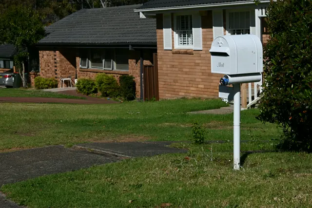 Mailbox and brick house in a sunny day