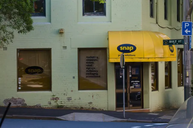 &ldquo;snap&rdquo; store, with a bright yellow cover over the entrance.