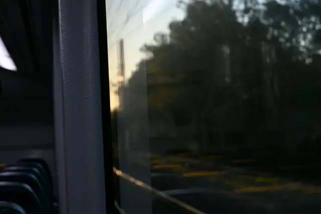 Train window with a nice pain texture. Sunset just visible outside.